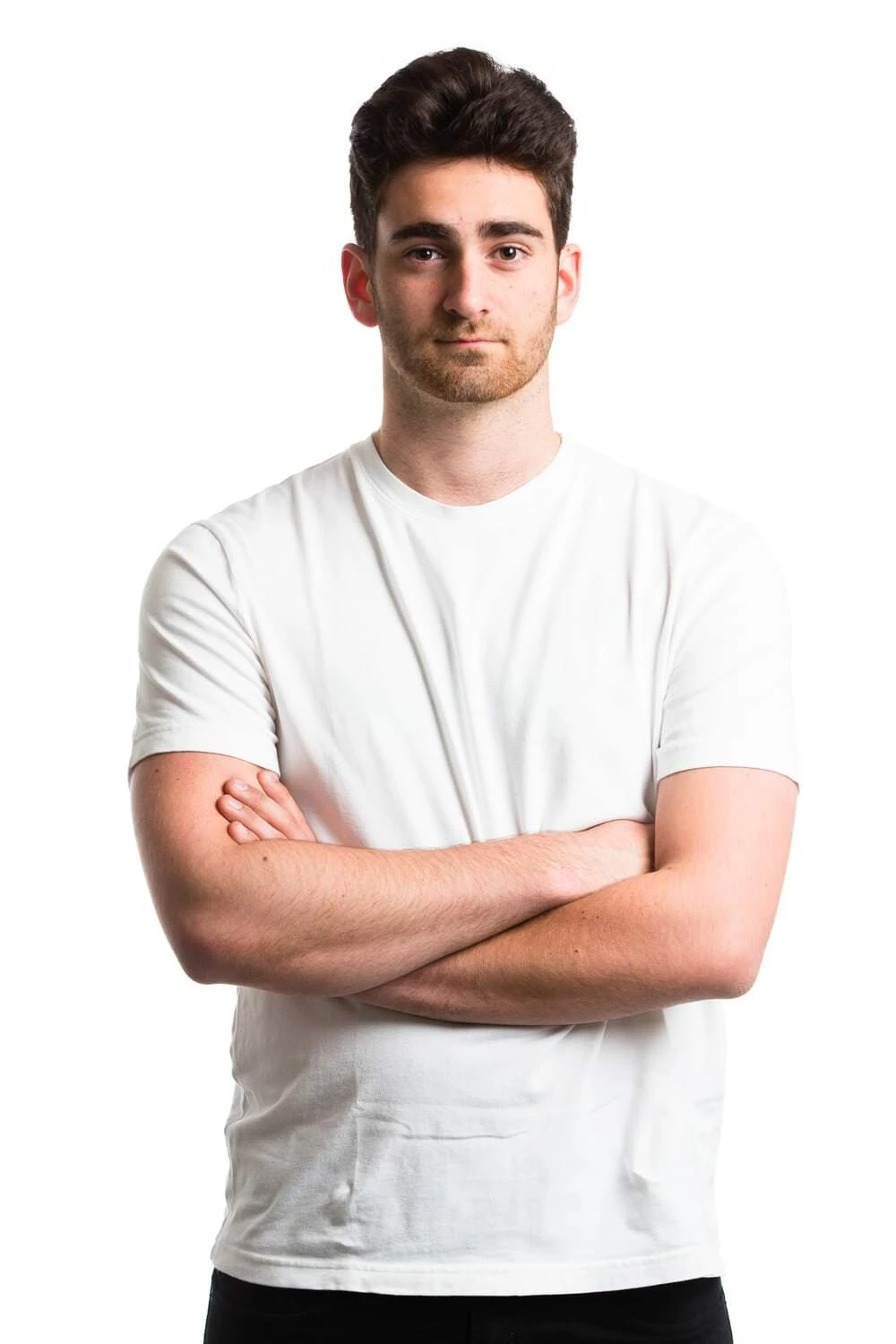 Young man in a white shirt with folded arms, photographed against a white background