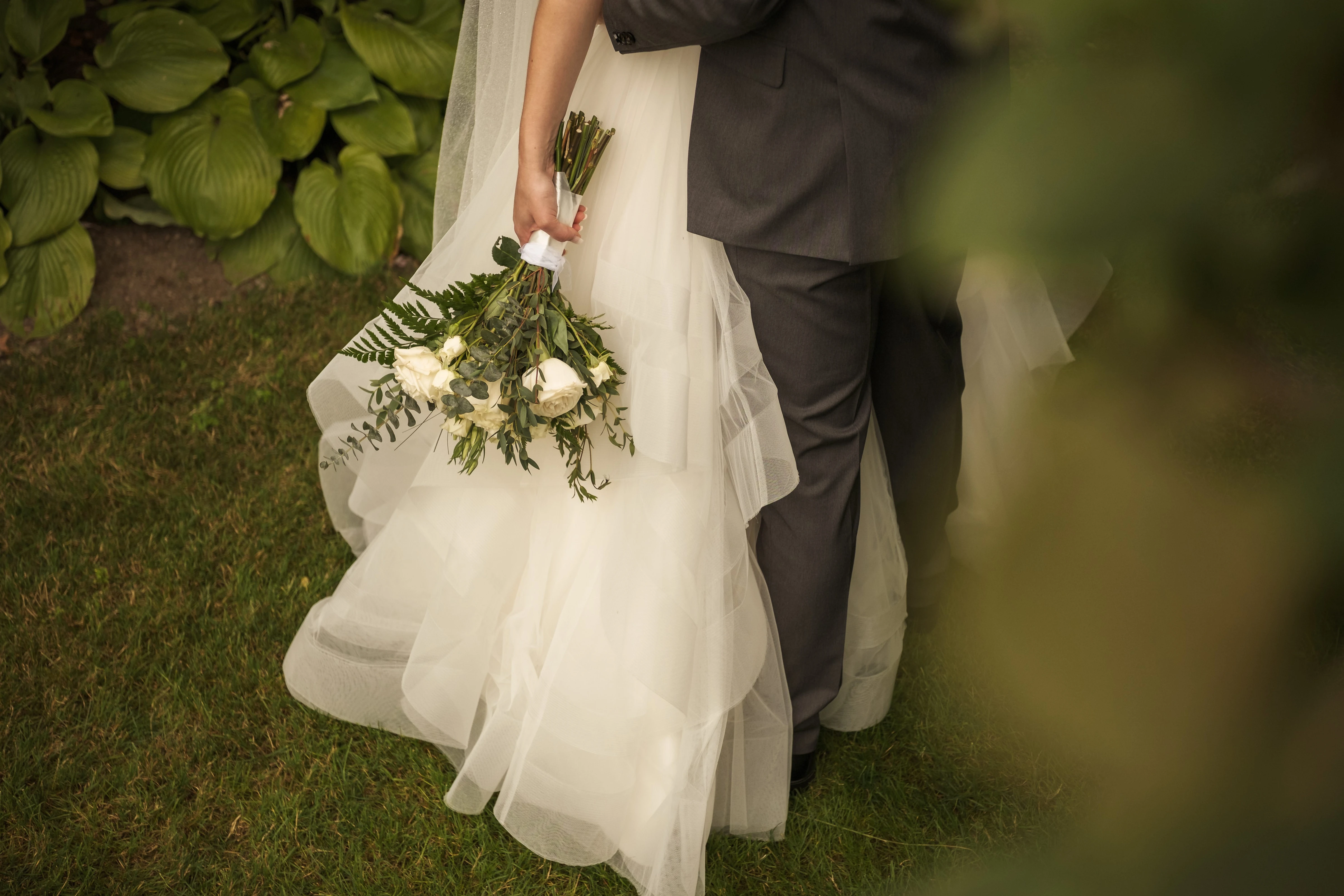 The newlyweds kiss in the warm light at the end of the day