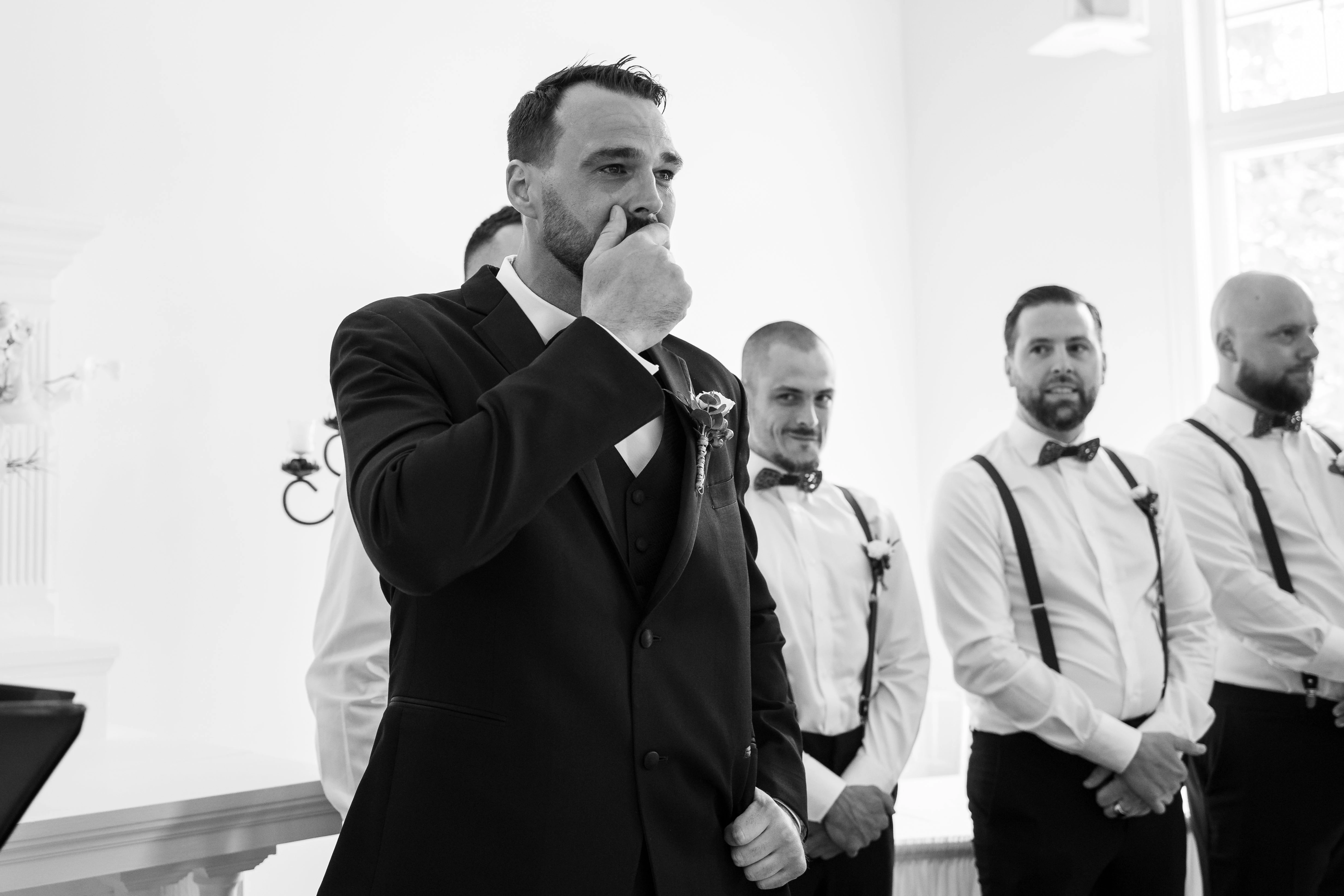 The newlyweds kiss in the aisle as their loved ones applaud