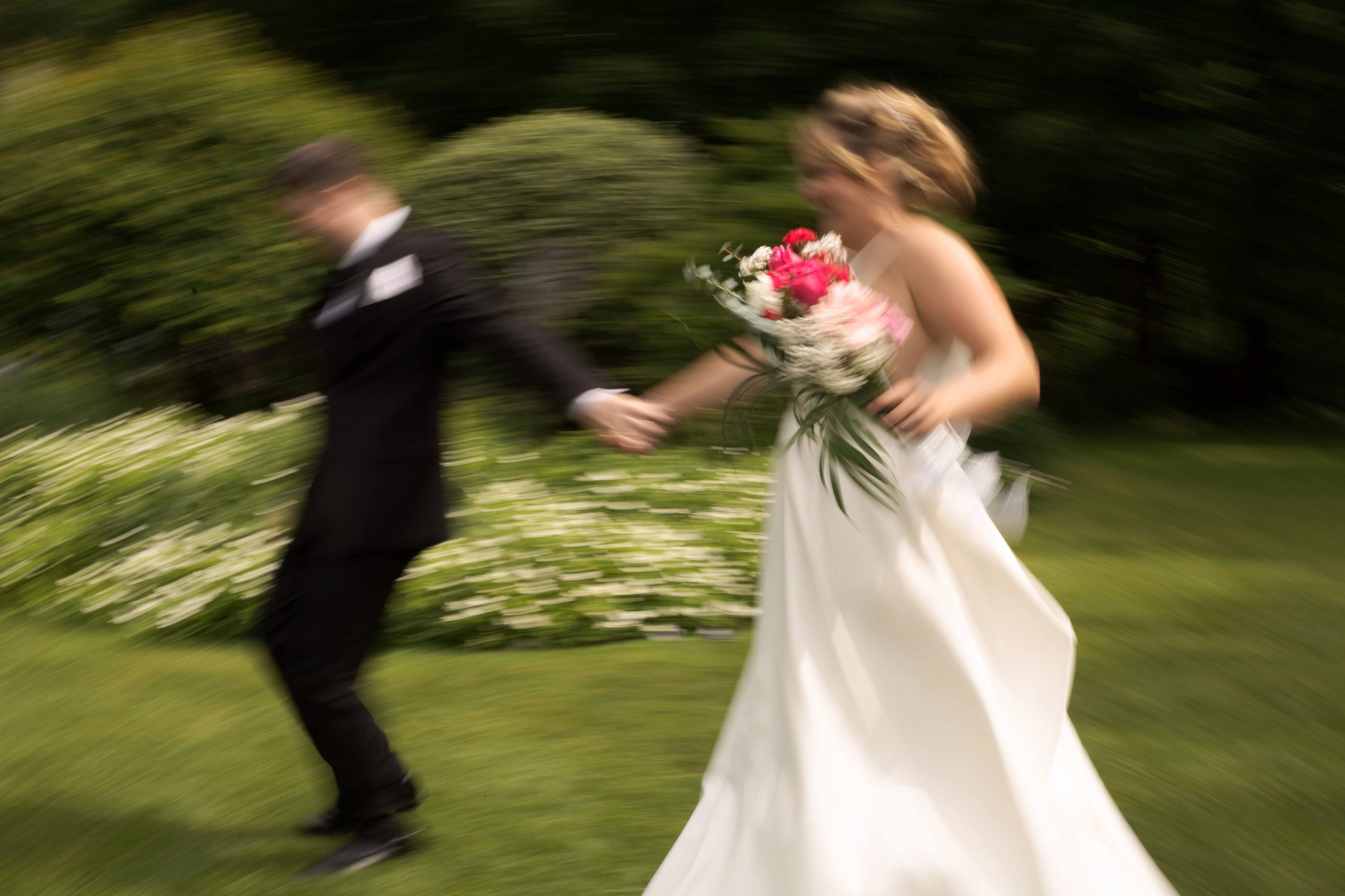 A quiet gesture between the newlyweds, photographed discreetly in black and white
