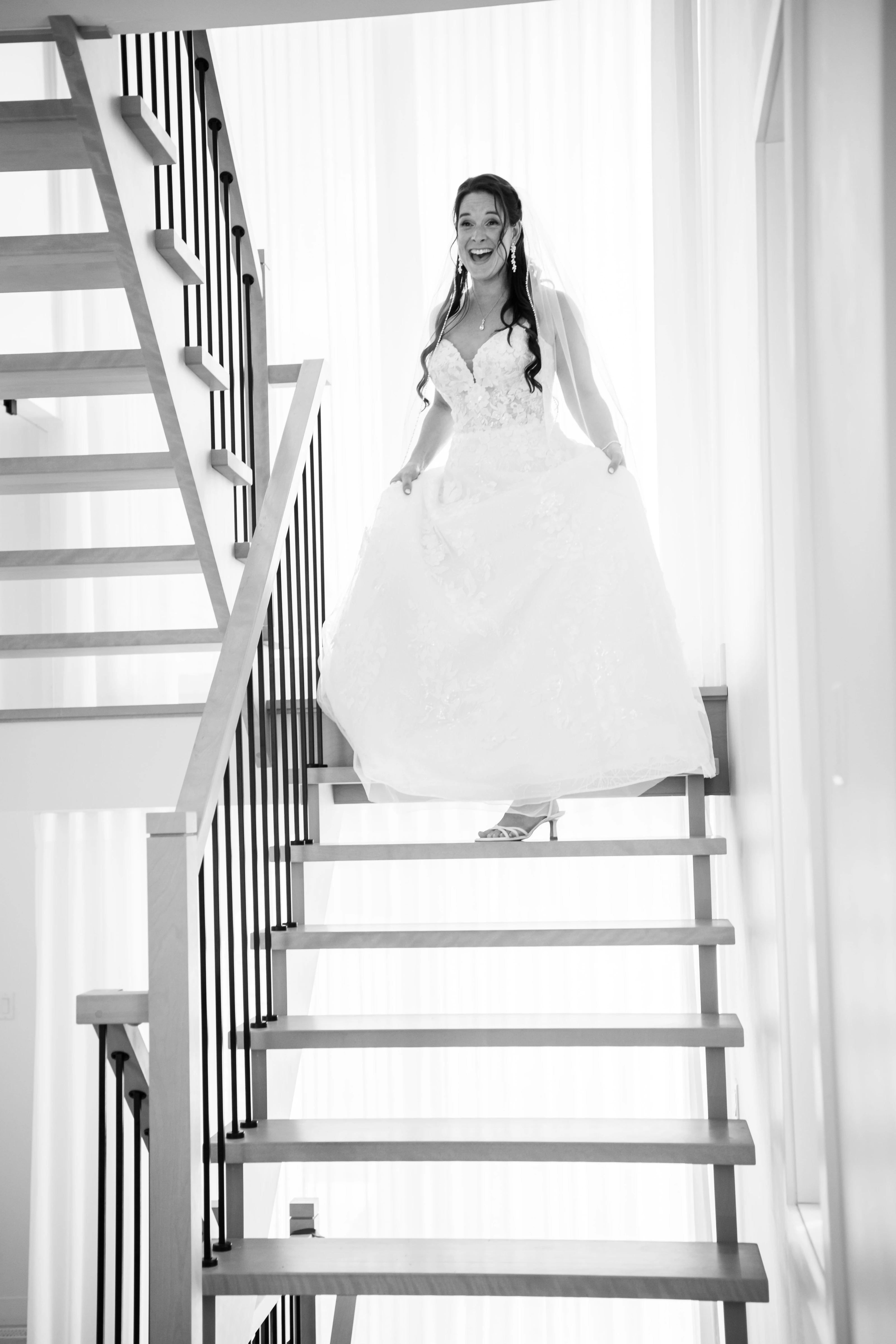 A loved one prepares the wedding dress in the soft light of a bedroom